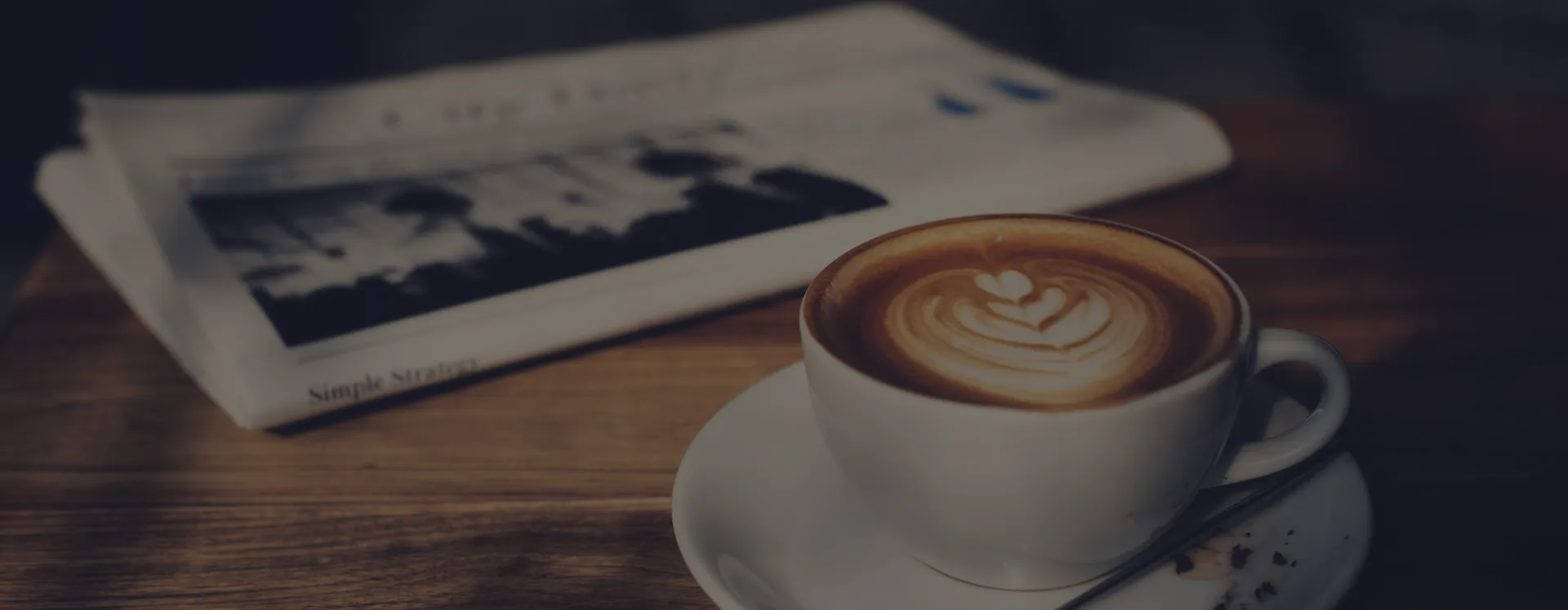 coffee cup and newspaper on a table