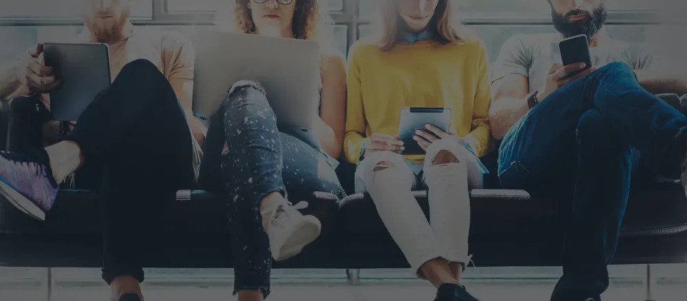 4 people sat cross legged waiting for a job interview